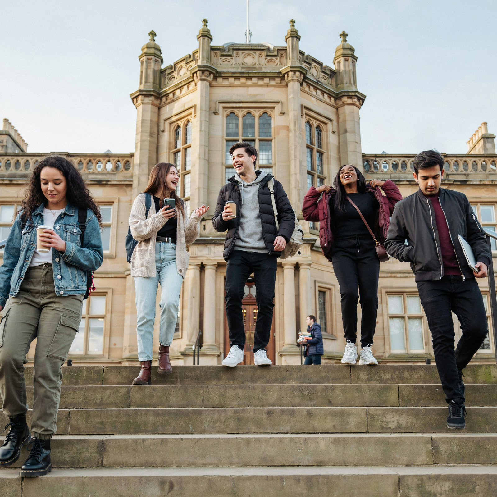University students walking down steps of Edinburgh campus building &mdash; all students should consider private Bexsero meningitis B vaccination before freshers week